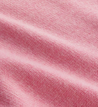 Close-up of soft, textured pink fabric with gentle folds and a cozy look, echoing the luxury of SRC Cashmere Sweatpant - Pink with ribbed ankles.