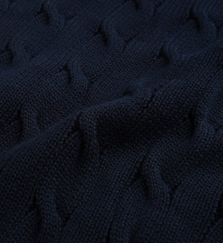 The SRC Cotton Cableknit Sweater in Navy features textured, wavy raised lines and soft cotton fabric—ideal for cozy unisex knitwear.