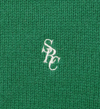 Kelly green lambswool SRC Wool Crewneck featuring white embroidered overlapping SPC letters at the center.