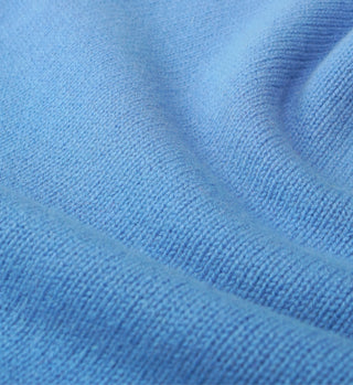 Close-up of the SRC Wool Crewneck - Ocean, showing soft, textured light blue lambswool with a visible knit pattern and gentle folds. Made in Italy.