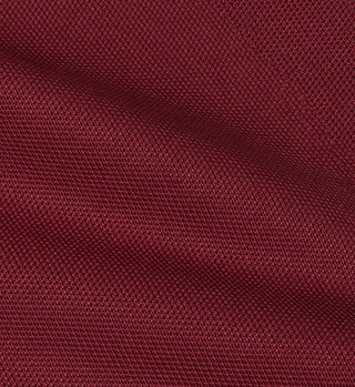 A close-up of high-quality, dark red textured fabric with a diagonal shadow, reminiscent of the premium materials used in the SRHWC Track Short - Merlot.